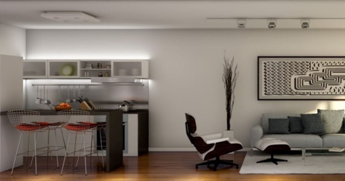 Interior de un apartamento del edificio Live Soho del estudio de arquitectos Aisenson con cocina con barra y living con sillones bajos