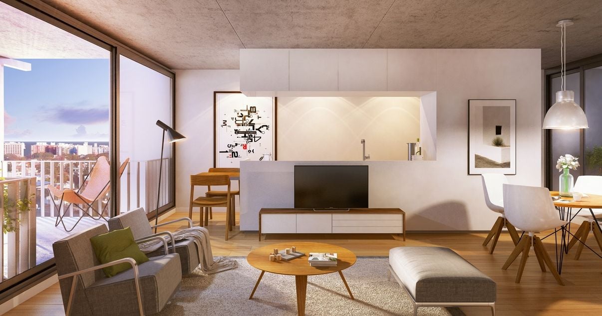 Interior de un livin en el edificio 01 Del Centro con sillones y colores cálidos de la desarrolladora inmobiliaria Vitrium Capital